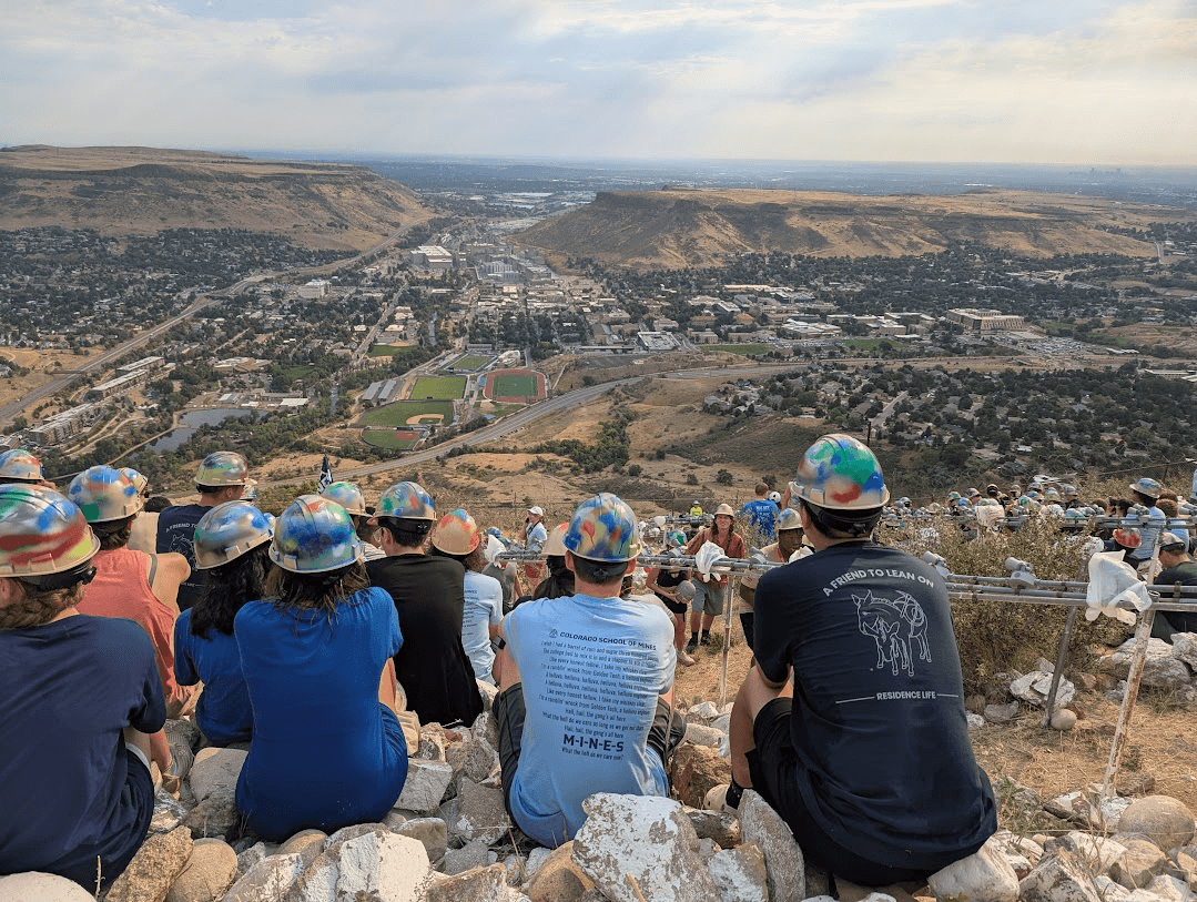 Students sitting on the M after the M climb